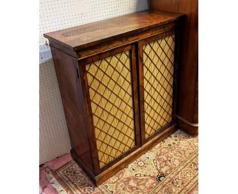 SIDE CABINET BY W &amp; C WILKINSON, 83cm x 34cm x 95cm, Regency rosewood with a pair of brass lattice doors enclosing adjust