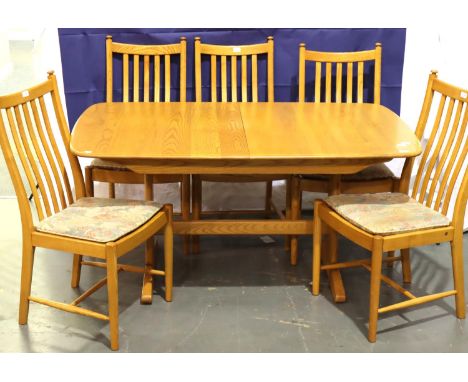 Ercol Windsor golden elm trestle extending dining table with central folding leaf and a set of six stick back dining chairs, 