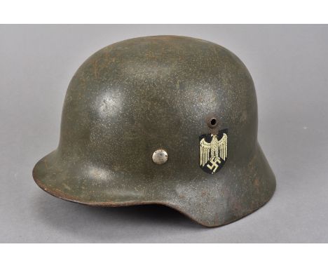 A German Army Double Decal M35 helmet, the green painted helmet with Heer decal to one side and National Colours to the other