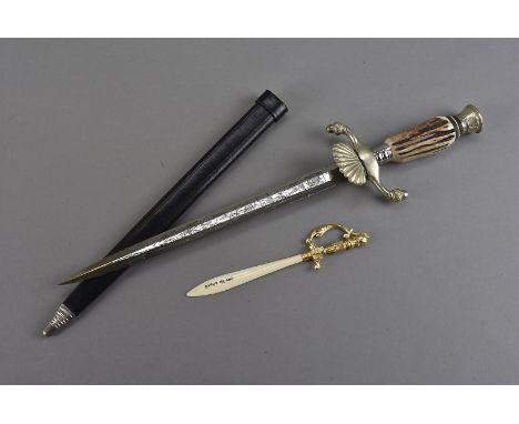 A German Hunting dagger, with decoratively engraved Solingen blade, having antler handle with white metal cross guard with ac