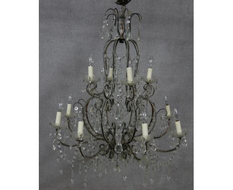 A metal framed sixteen branch chandelier with twelve light fittings in two tiers all with cut crystal drops. Dia.80cm 