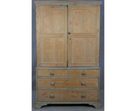 A 19th century pine press cupboard fitted with linen slides above two short and two long drawers on bracket feet. H.195 W.121