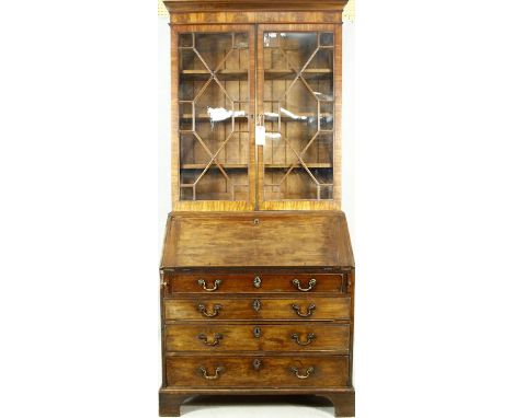 A Georgian mahogany two section bureau bookcase with upper astragal glazed top above fall front enclosing fitted interior rai