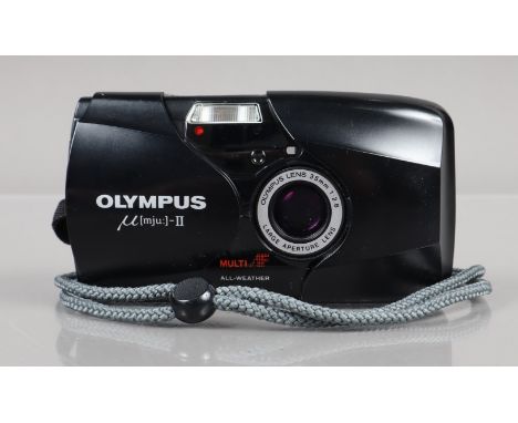 An Olympus mju II Compact Camera, black, powers up, shutter working, flash working, self timer working, body G, light wear, e