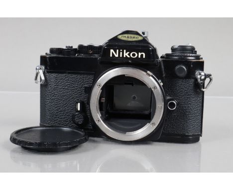 A Nikon FE Camera Body, black, serial no 3925678, shutter working, meter responsive, self timer working, body G, tiny ding to
