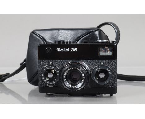 A Rollei 35 Compact Camera, made in Germany, black, serial no 3175995, shutter working, meter responsive, body G, light wear,