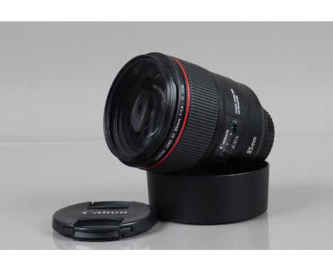 A Canon EF 85mm f/1.4 L IS USM Lens, serial no 7100001228, auto focus working, barrel VG, elements VG, with Walimex pro slim 