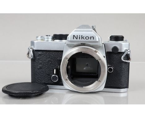 A Nikon FM Camera Body, chrome, serial no 3476956, shutter working, meter responsive, self timer working, body G, some brassi