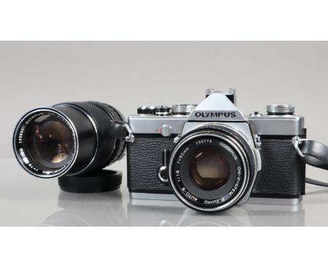 An Olympus OM-1 SLR Camera, chrome, serial no 18284, shutter working, meter working, self timer working, body G, some pitting