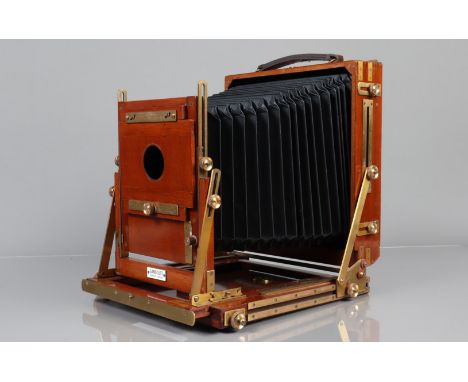 A Gandolfi Mahogany and Brass Whole Plate Camera brass bound, possibly 1970s, with 8½ x 6½ in back, focusing screen intact an