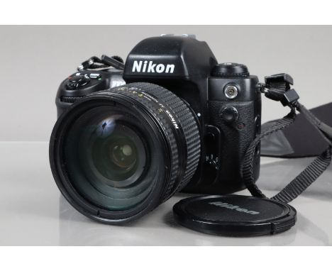 A Nikon F100 SLR Camera, powers up, shutter working, appears to function as should, body G, slight wear, with AF Nikkor 24-12