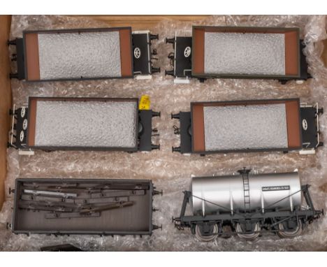 A group of four loose O gauge coal wagons: together with a 4 ton open wagon and a Unigate Creameries tank wagon (6)