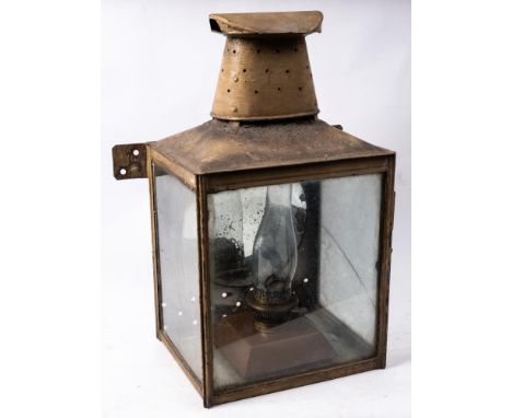 A large station wall lantern: of square form with oval chimney and circular reflector to interior, with Hinks patent burner, 
