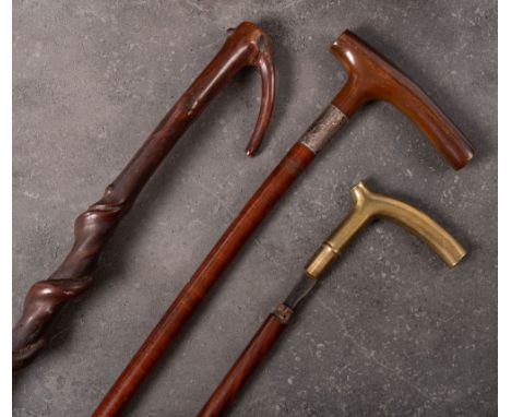 A silver mounted Plantation walking stick: (assay rubbed) together with a bras handled walking stick inscribed 'Col C M Hosky
