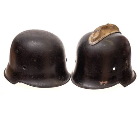 A WWII M1934 pattern German civil defence helmet: lacking insignia, retains leather liner and chin strap, together with a WWI