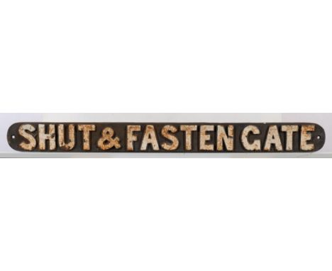 A cast iron sign 'Shut &amp; Fasten Gate': white raised text, 7.5 x 80.5cm
