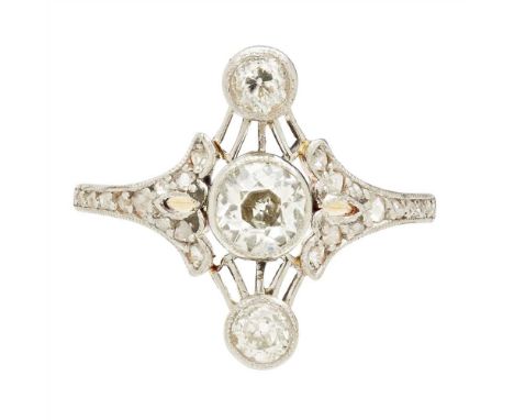 A Belle Époque diamond set ring millegrain set with three graduated old round-cut diamonds in a pierced surround, the shoulde