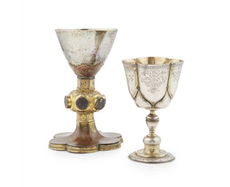 A silver and gilt on copper communion chalice possibly 16th century, the plain bowl clasped with gilt leaf clasping, the knop