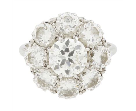 A diamond set cluster ring claw set with an old round-cut diamond in a border of round brilliant-cut diamonds, to a plain whi