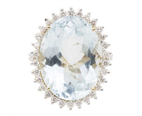 A large aquamarine and diamond set cocktail ring claw set with a large oval mixed-cut aquamarine in a border of small round b