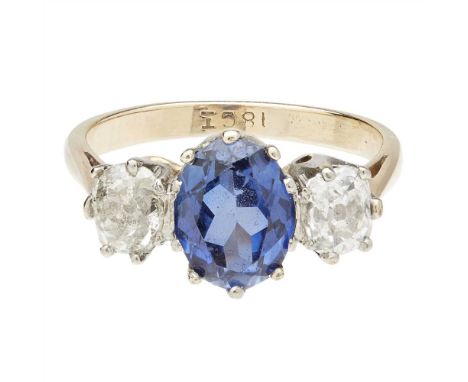 A sapphire and diamond set three stone ring claw set with an oval-cut sapphire, flanked to either side by a cushion-cut diamo