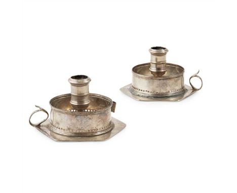 A pair of chamber sticks the hexagonal white metal bases with stamped mark L&amp;R, loop handle, engraved crest and central c