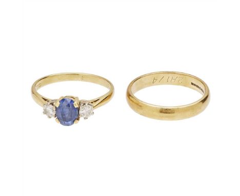 A sapphire and diamond set ring claw set with an oval-cut sapphire, flanked to either side by a round brilliant-cut diamond, 