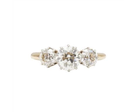 A three stone diamond ring claw set with three graduated old round-cut diamonds, to a plain shank, stamped 18ct (Dimensions: 