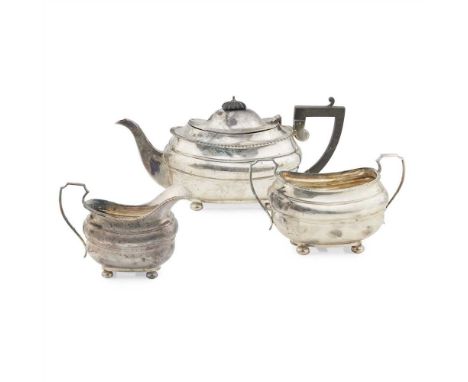 A three piece tea service PFM, Sheffield 1912, comprising teapot, twin handled sugar basin and milk jug, of oval waisted form