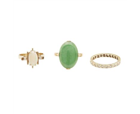 Three gem set rings to include a cabochon jade set ring, indistinctly marked; an opal and diamond set ring, stamped 375; and 