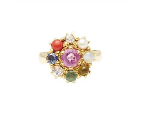 A gem set Navaratna style ring claw set with a central pink sapphire, in a border of various gemstones including blue sapphir