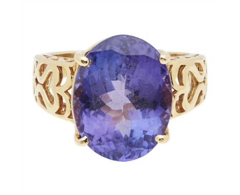 A Tanzanite set cocktail ring claw set with a large oval-cut Tanzanite, the gallery and shoulders with pierced scrolling deta
