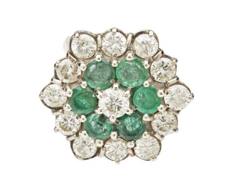 An emerald and diamond set cluster ring claw set with a central round brilliant-cut diamond, in a double border of round bril