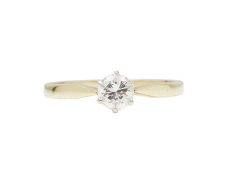 A single stone diamond set ring claw set with a round brilliant-cut diamond, to a plain yellow metal shank stamped 18CT (Dime