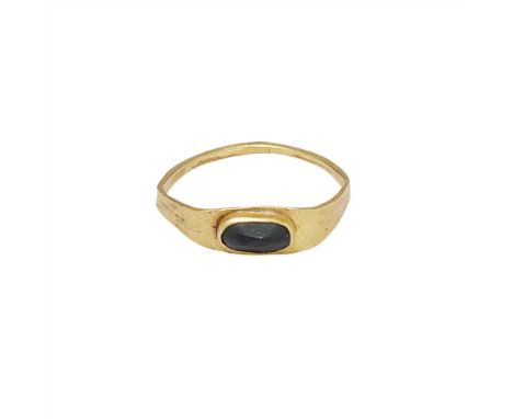 An antique gem set ring possibly 17th century, the plain satin finish gold mount set with a single rectangular faceted gem st
