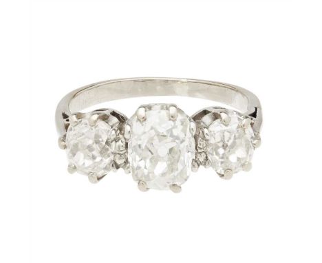 A three stone diamond set ring claw set with three graduated old cushion-cut diamonds, to a plain white metal shank, unmarked