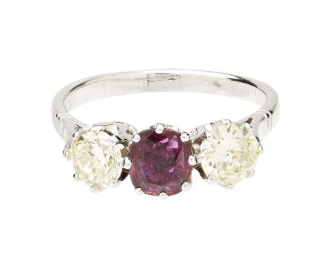 A ruby and diamond set three stone ring claw set with a cushion-cut ruby, each shoulder claw set with a round brilliant-cut d