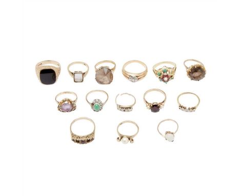 A large collection of gem set rings to include a 9ct gold onyx set ring, a single stone opal set ring, a 9ct gold garnet set 