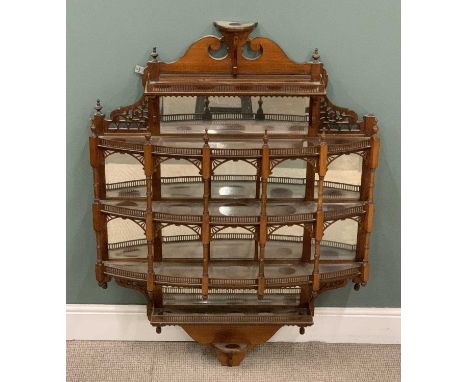 HIGHLY ORNATE EDWARDIAN MAHOGANY WALL ETAGERE of architectural form having fretwork galleries, bevelled mirror glass and pier