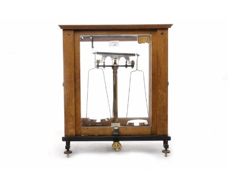 SET OF VINTAGE CHEMICAL SCALES
with ten graduated brass weights, contained in an oak and glazed case, with sliding and hinged