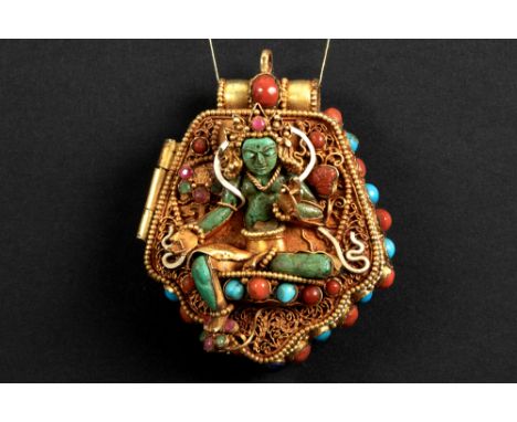 Tibeto Nepalese ghau in yellow gold on silver with turquoise, lapis lazuli, coral, ruby and emerald and with the depictions o