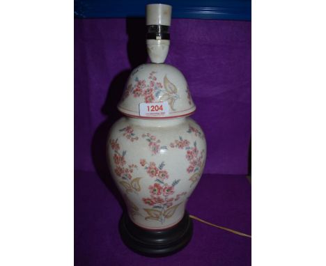 An early 20th century urn form lamp base having hand decorated floral design