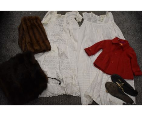 A selection of vintage textiles including childs red jacket, fur collars and night dress