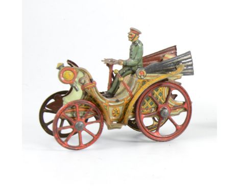 An early 20th Century tin-plate vintage motor car, with spoked wheels, driver and steering wheel, 9cm long.