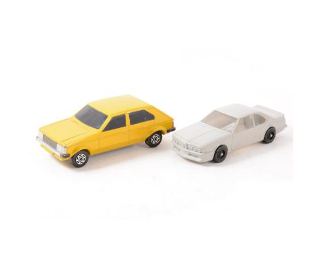 Two Corgi Toys prototypes; a Chrysler Horizon GLS wooden handmade model, 11cm, and a BMW 7 series plastic model, 11cm, both h