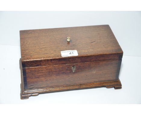 Oak tea caddy with bone finial on stepped feet 