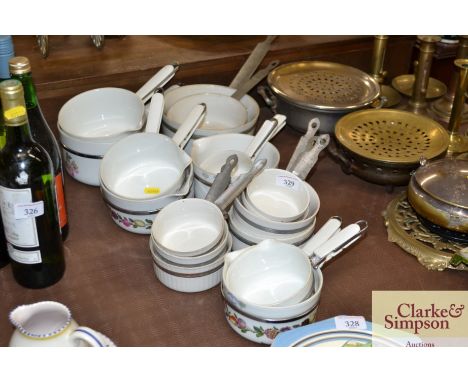 A quantity of vintage enamel and pottery saucepans