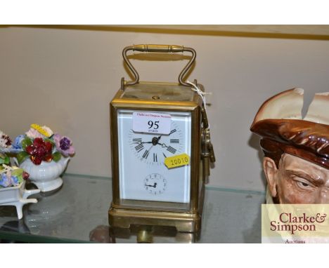 An alarm repeat brass cased carriage clock