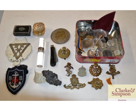 A tin and contents to include a small papier maché snuff box, various coinage, badges etc.