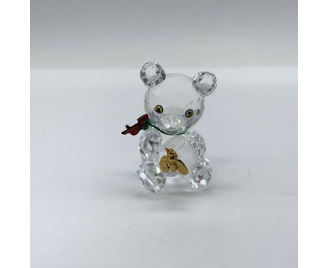 Charming crystal clear faceted figure that depicts Kris Bear with a green and red ribbon around his neck as he holds a froste